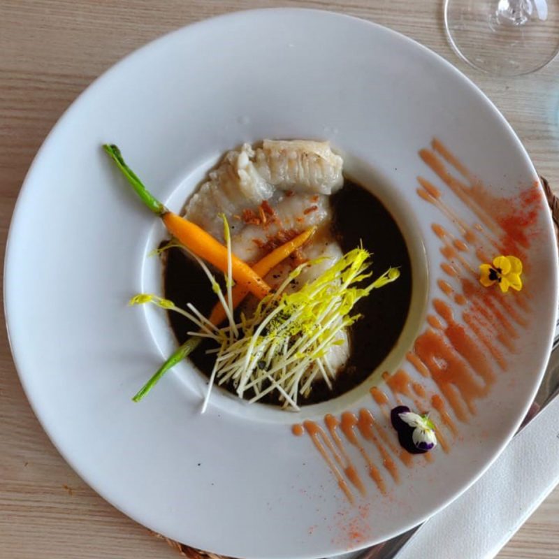 Receta de corte de rodaballo confitado sobre crema de trompetas de la muerte con germinado de espárragos